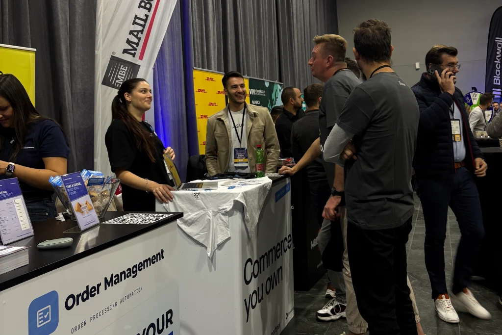 Visitors talking with the Agilo team at the booth