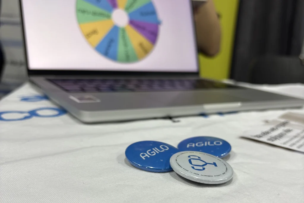 Agilo pins in front of the lucky wheel at the booth